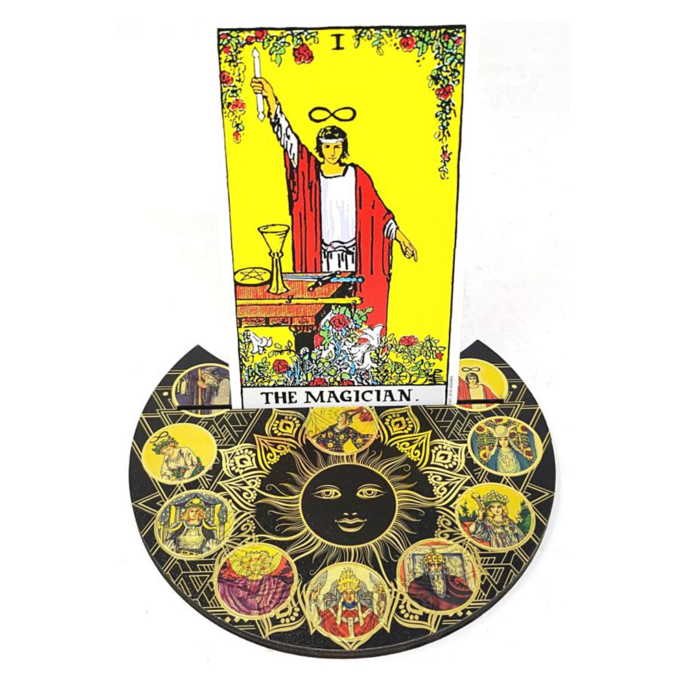 Tarot card featuring 'The Magician' with a decorative border is sitting on a tarot holder featuring a sun design.