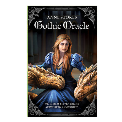 Cover of Anne Stokes Gothic Oracle Deck's included booklet. Features a a royal woman wearing a fairy tale blue dress and gold headband flanked by two gold/bronze dragons.