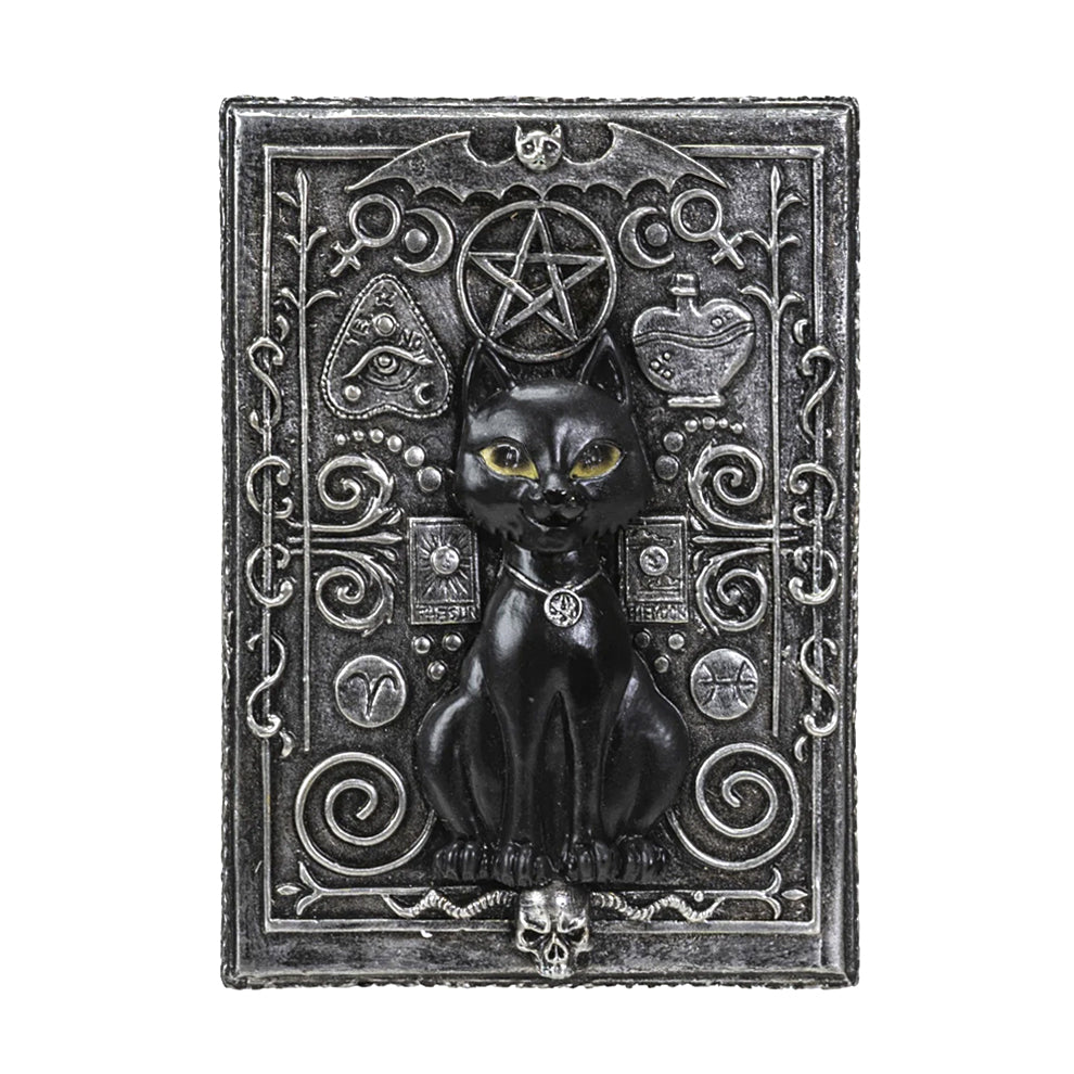 Decorative plaque with a black cat, pentacle, and other symbols on an ornate background.