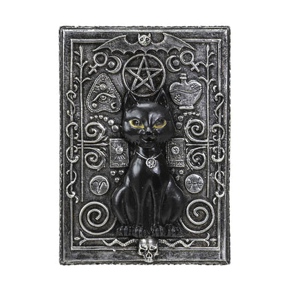 Decorative plaque with a black cat, pentacle, and other symbols on an ornate background.