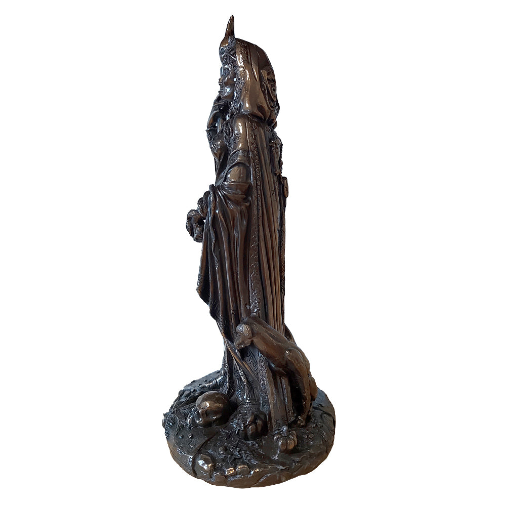 Statue of Hecate holding a torch and a dagger flanked by black dogs and standing close to a skull (seen from the side)
