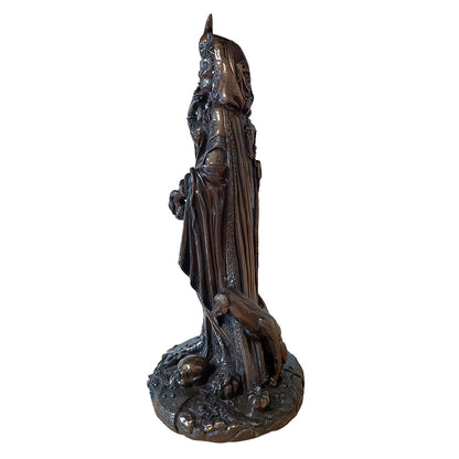 Statue of Hecate holding a torch and a dagger flanked by black dogs and standing close to a skull (seen from the side)