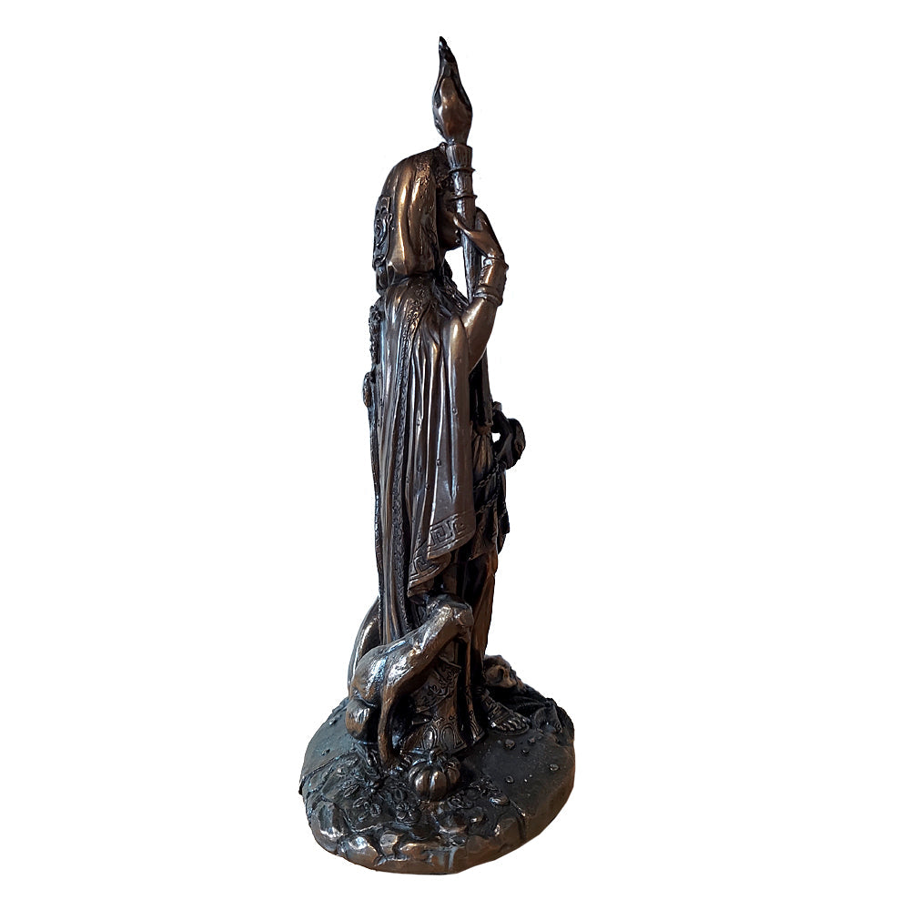 Statue of Hecate holding a torch and a dagger flanked by black dogs and standing close to a skull (seen from the right side).