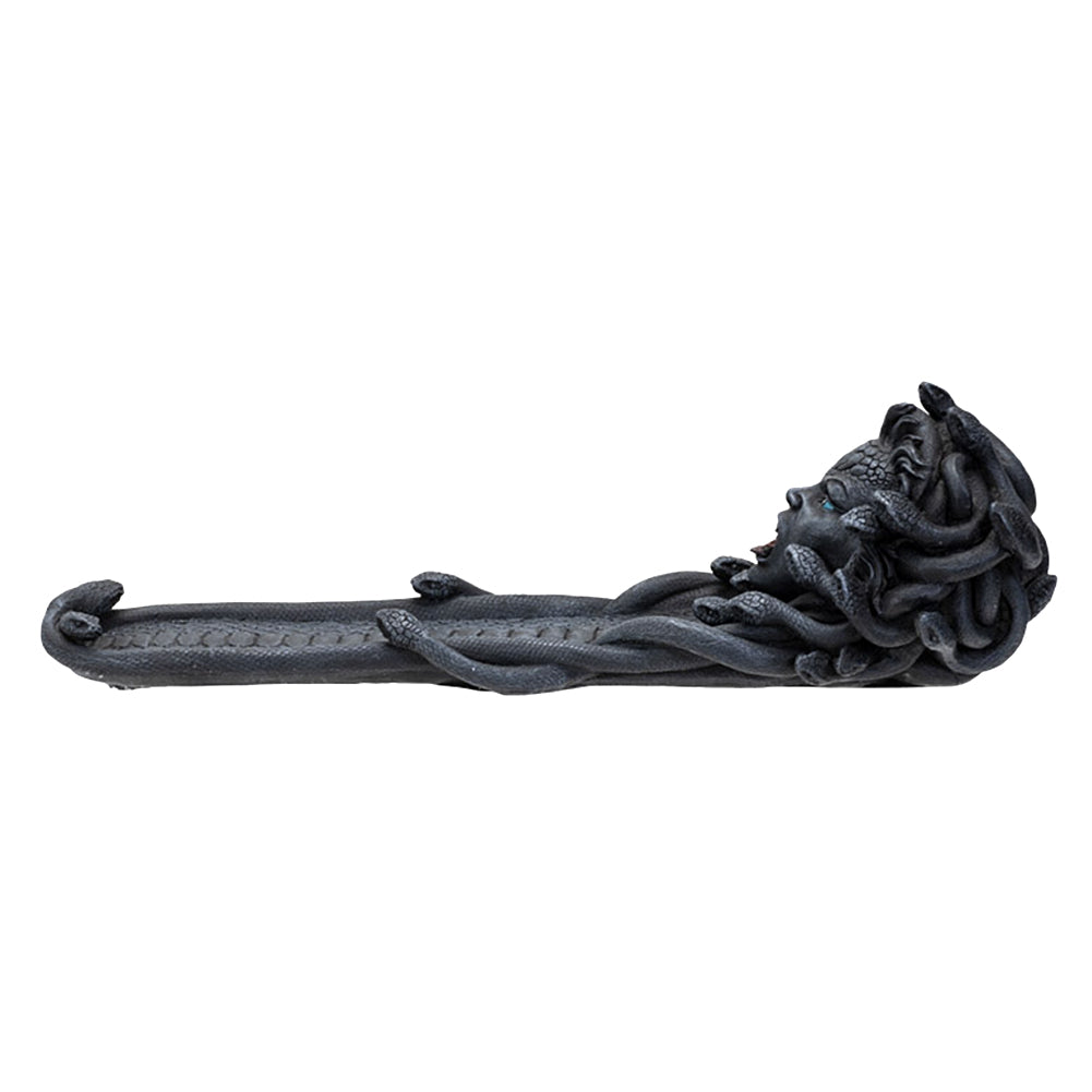 Dark grey resin cast Medusa incense burner with her at one end of the burner.