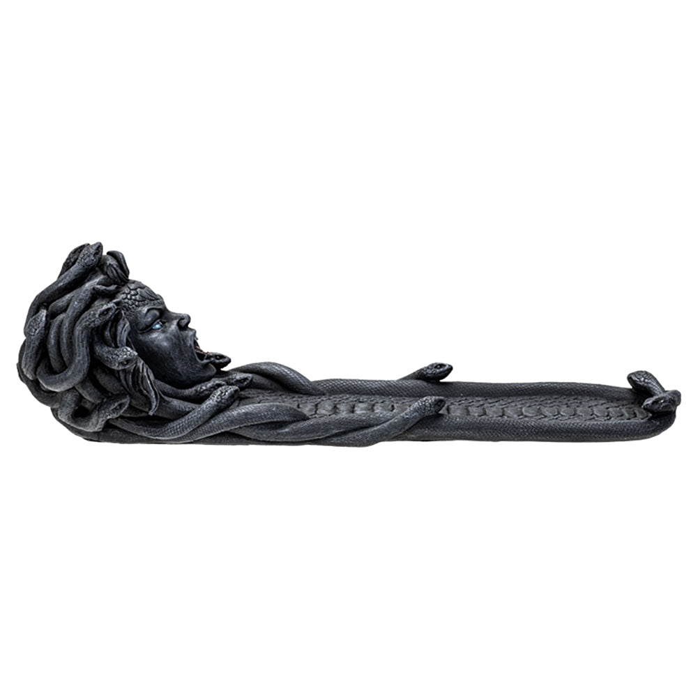 Dark grey resin cast Medusa incense burner with her at one end of the burner.