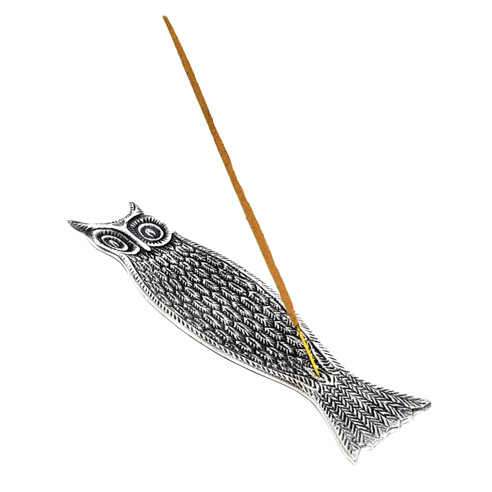 Decorative incense stick holder shaped like a fish on a white background