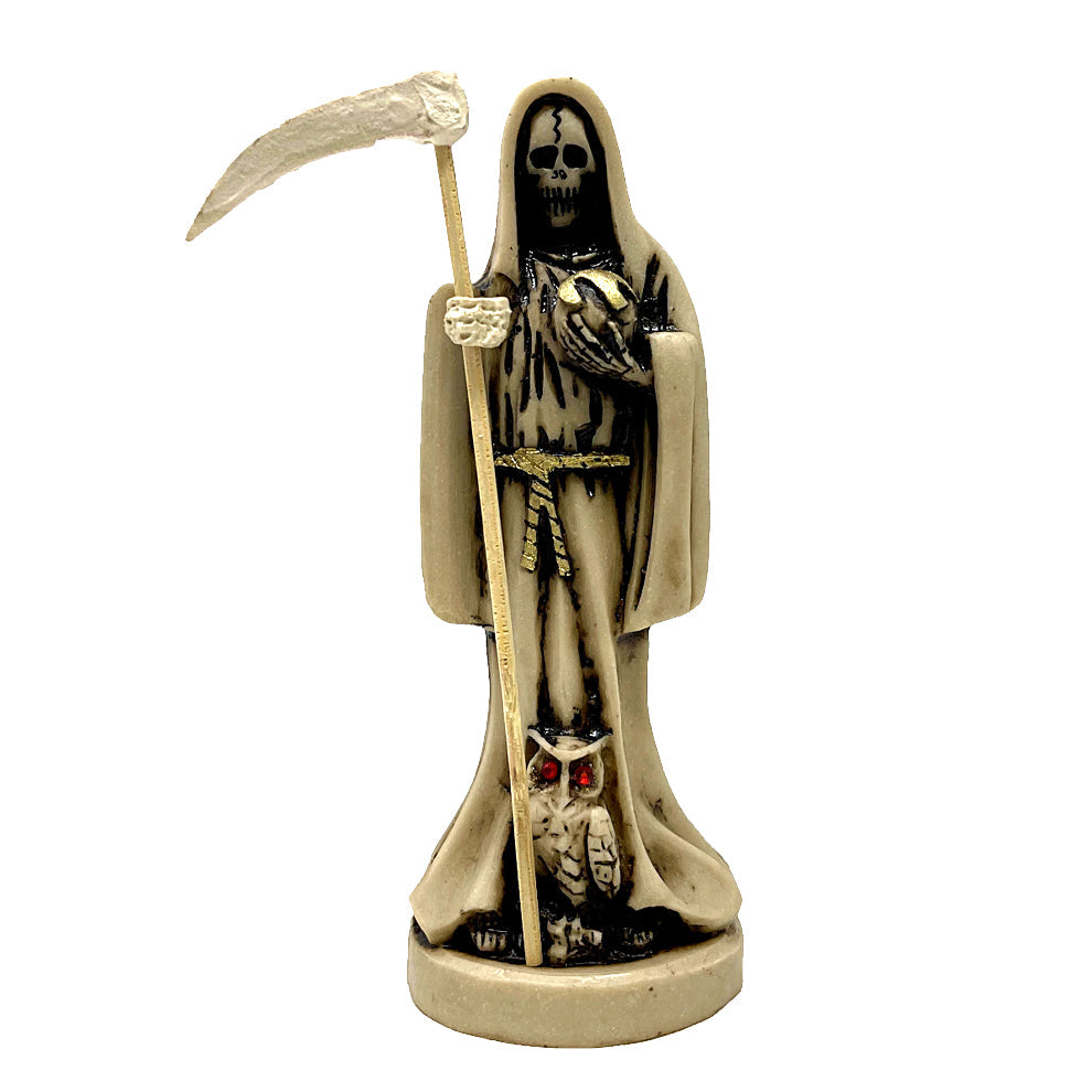 Statue of Santa Muerte holding a scythe with an owl at her feet.