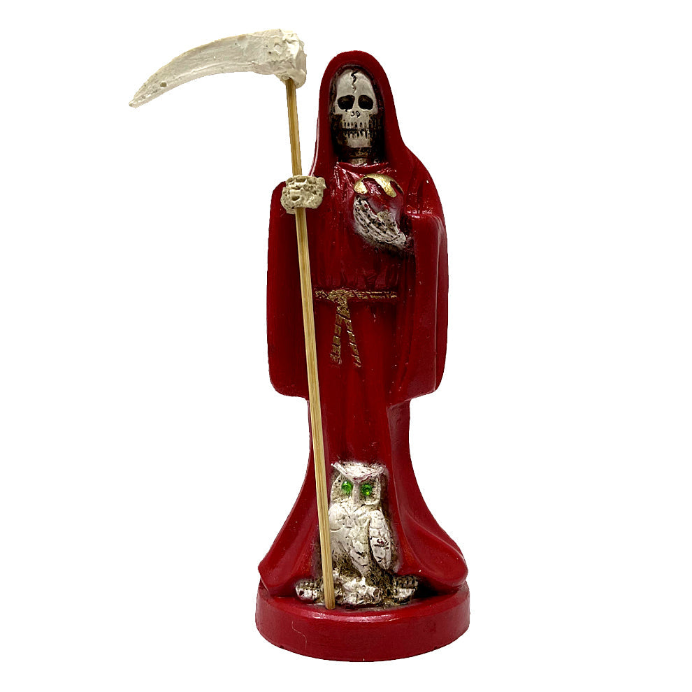 Statue of Santa Muerte in red robes holding a scythe with an owl on a white background