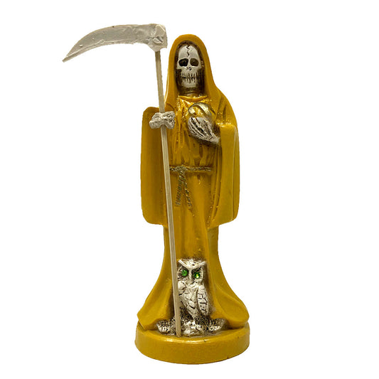Statue of Santa Muerte in yellow robes holding a scythe with an owl at its feet on a white background