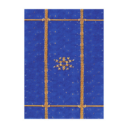 Decorative blue paper with gold patterns and a star design on a white background