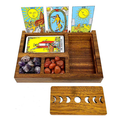 Wooden tarot card holder with tarot cards, crystals, and a moon phase ruler on a white background.