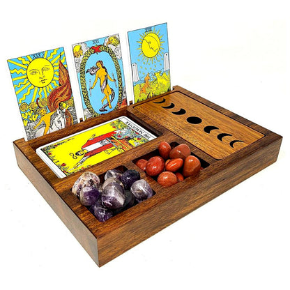 Wooden tarot card holder with tarot cards, crystals, and stones on a white background